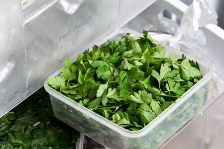 Homemade frozen vegetables in plastic box ready for freezingの写真素材