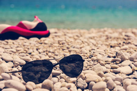 Glasses on the pebbles beach in Oludeniz Turkeyの写真素材