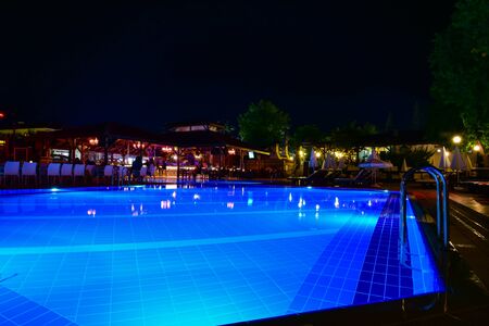 Night view of beautiful swimming pool in tropical resort in Oludeniz Turkeyの写真素材