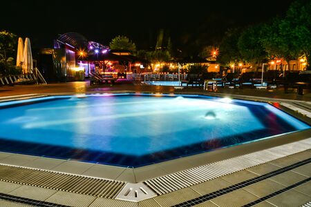 Night view of beautiful swimming pool in tropical resort in Oludeniz Turkeyの写真素材