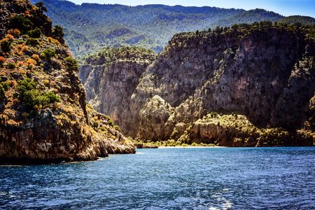 View of Butterfly Valley from a sailing boat with bright sea and high mountains.の写真素材
