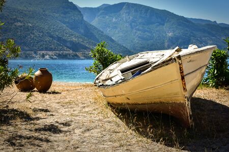 Abandoned boat on a sandy beach in Oludeniz Turkeyの写真素材
