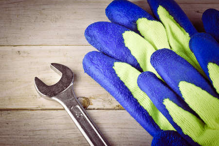 The different forms of screws and a wrench with nuts and gloves, with vignette effectの写真素材
