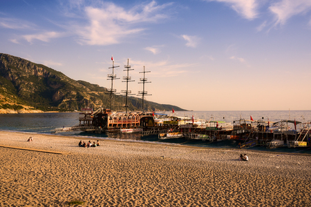 Oludeniz, Turkey - May 07, 2017:  Boats returned from a daily tours and some tourists still staying on the beach. Editorial photo.のeditorial素材