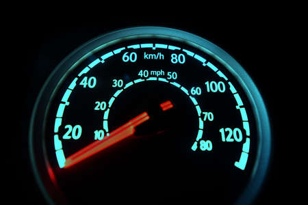 Specific speedometer on dark background. It comes from HGV truck dashboard, blurred, miles and...