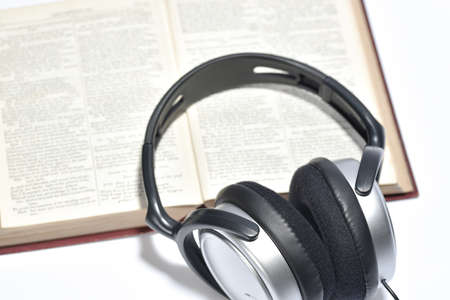 A set of books being played as audio through the headphone speakersの写真素材