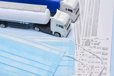 Two lorry toys, and face mask in concept about transport departament against coronavirus pandemic.の写真素材