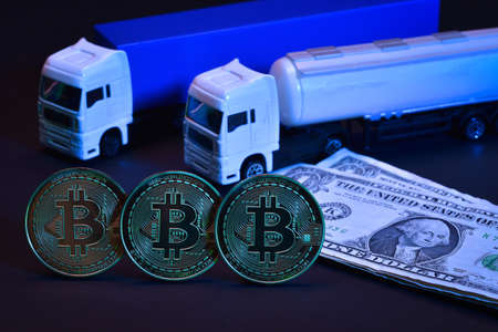 Bitcoin cryptocurrency mining and transport concept. Blockchain technology. Toy truck with golden...