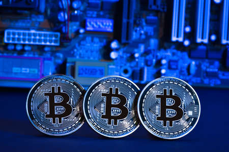 Bitcoins on the motherboard. Crypto currency Gold Bitcoin - BTC - Bit Coin on colorful background