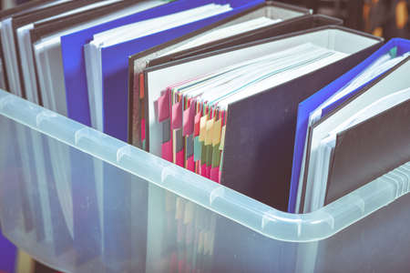 Documents and files folders are placed in a plasic box.の写真素材