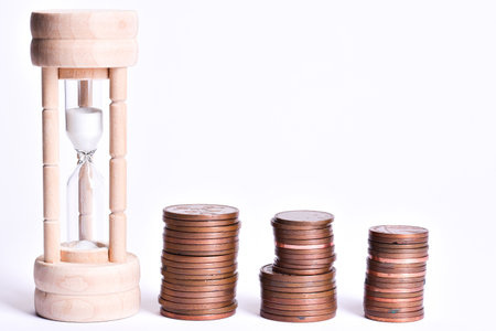 Time is money concept for business efficiency, golden coins and hourglass clockの写真素材