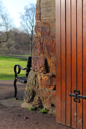 Wooden door and bench in a park in London, UK.の写真素材