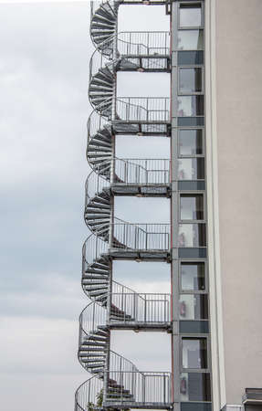Spiral staircase as an emergency exit on the outside of the houseの写真素材