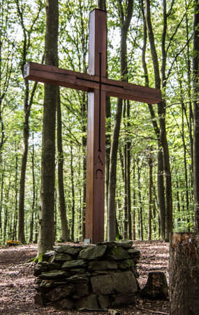 Memorial with cross in the cemetery forestの写真素材