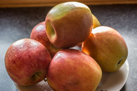 red cheeked apples on plate