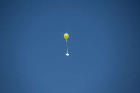 yellow balloon in the skyの写真素材