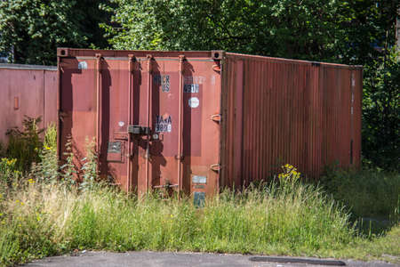 red brown steel container in the grassのeditorial素材