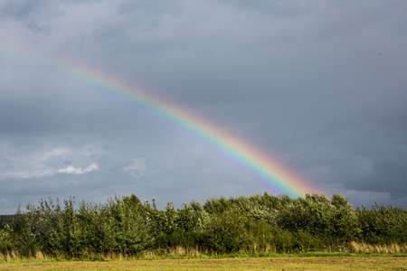 Rainbow over airfield under cloudy skyの写真素材