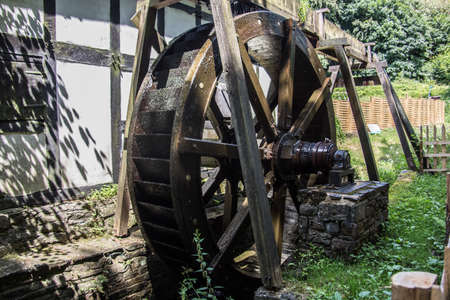 Half-timbered greening with water wheelの写真素材