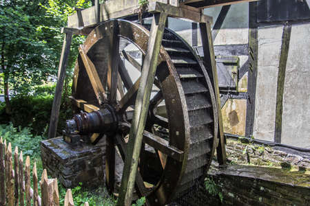 Half-timbered greening with water wheelの写真素材