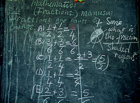 green chalkboard in african school with math problems