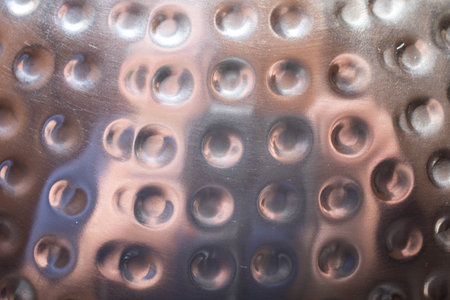 Metal surface with round dents in the surfaceの写真素材