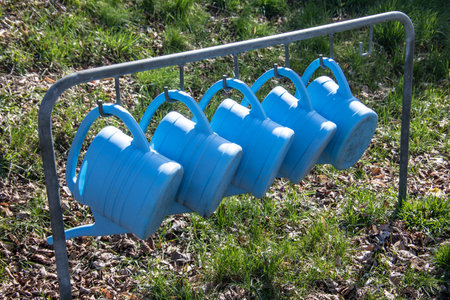 Plastic watering cans are hung at the cemeteryの写真素材