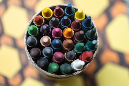 Colorful crayons in a bowl on a wooden background.の写真素材