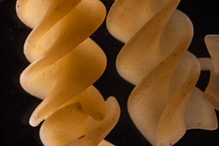 yellow spiral pasta under the microscopeの写真素材