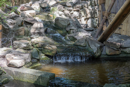 River course littered with rocks with waterfall in Oberhausenの写真素材