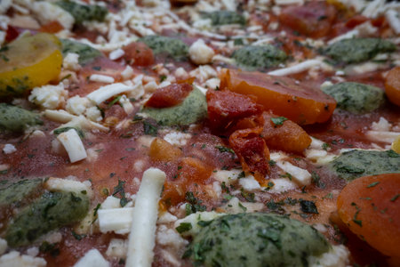 Vegan frozen pizza with tomatoes, cheese and peppers close-up