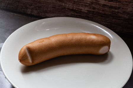 large sausage lies on a plate close-upの写真素材