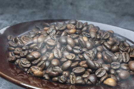 brown fragrant roasted coffee beans with fog close up