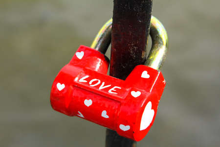 The red padlock with many little hearts