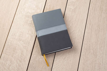 Notebook Scheluide on wooden background