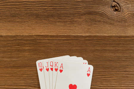 Poker cards royal flush the highest ranking hand in holdem poker on wooden backdrop
