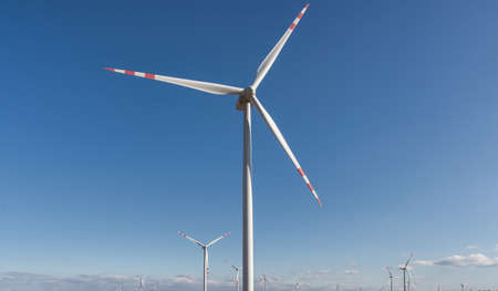 Natural Alternative Energy - windturbines windmill producing electricity on a sunny day copyspaceの写真素材