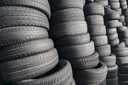 Pile of rubber automotive tyres, car tyres recycling backgroundの写真素材