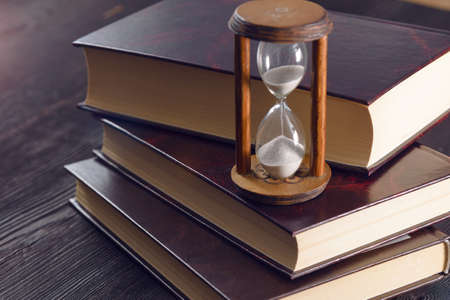 Hourglass as time passing concept for studying deadline, urgency and running out of time.