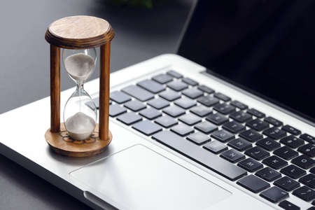 Hourglass as time passing concept for business studying deadline, urgency and running out of time...