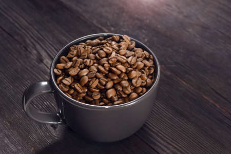Coffee beans in coffee cup on backgroundの写真素材