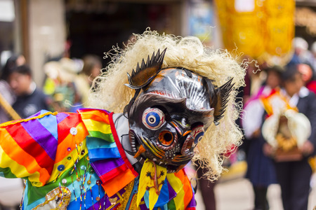 Pisac, Peru - July 16, 2013  masked dancers at Virgen del Carmen parade