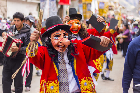 Pisac, Peru - July 16, 2013  masked dancers at Virgen del Carmen paradeのeditorial素材