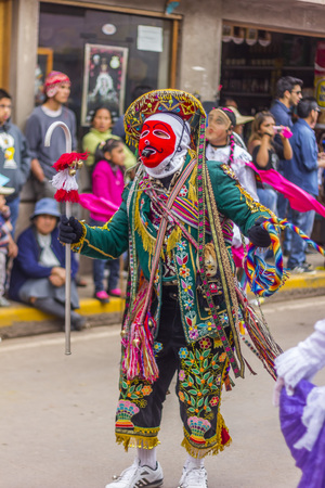 Pisac, Peru - July 16, 2013  masked dancers at Virgen del Carmen paradeのeditorial素材