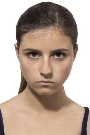 one beautiful teenage girl portrait angry in white backgroundの写真素材