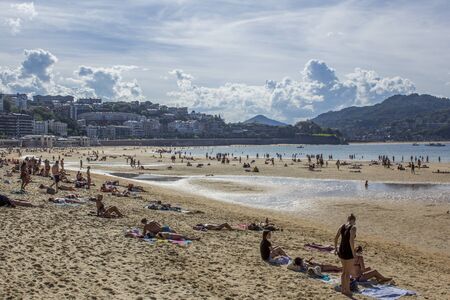 San Sebastian, Spain - September 15, 2014: People sunbathing in La Concha Beachのeditorial素材