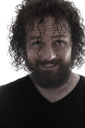 one bearded mad man smiling portrait on white backgroundの写真素材