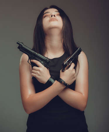 Shot of a military woman posing with guns