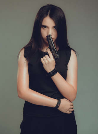 Shot of a military woman posing with guns