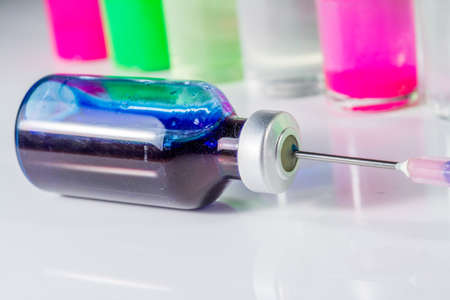 set of  medizine bottle with colored liquid and injectionの写真素材